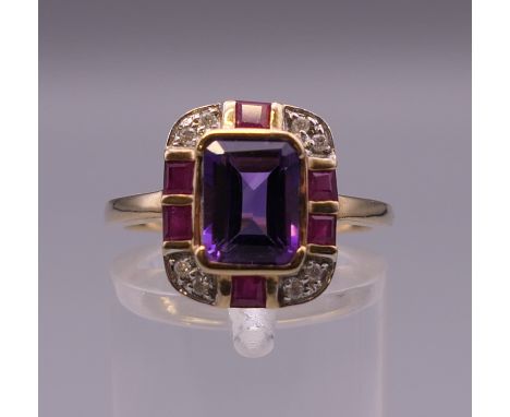 An Art Deco style 9 ct gold amethyst, ruby and diamond ring. Ring size O.