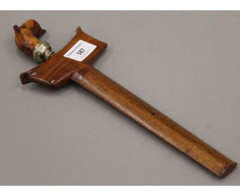 A Sumatran kris dagger with carved hardwood handle and sheath. 30.5 cm long.