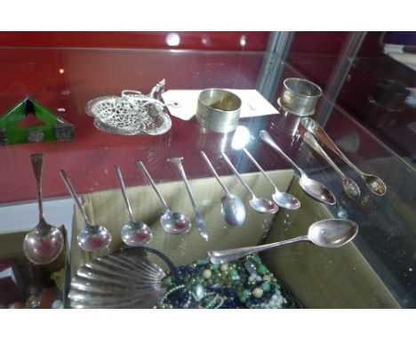 A collection of sliver items to include a pierced Ladle, a set of six tea spoons, sugar tongs, two napkin rings, three spoons
