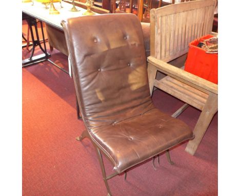 A Italian designer easy chair with brown button on back leather upholstery on wrought iron frame