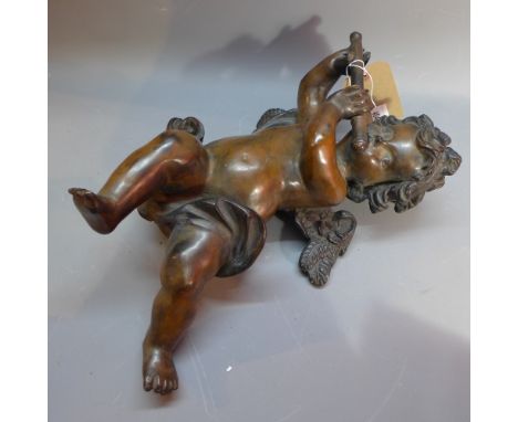 A bronze figure of a cherub playing a flute, having a hoop to the rear for hanging. H-43cm, W-26cm, D-15cm 