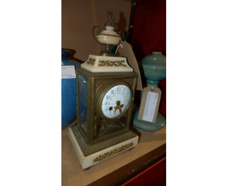A 19th Century French alabaster and brass mantle clock with urn finial and ceramic dial, raised on peg feet, H;35cm W:16cm D: