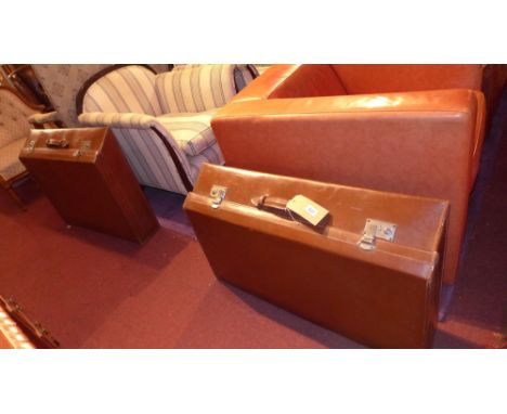 A graduated pair of brown leather automobile suitcases having slanted fronts. H-33cm, W-89cm, D-64cm stacked together. 