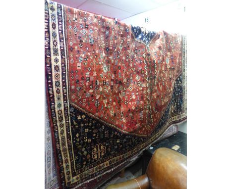 A South West Persian carpet , 295cm x 210cm, the central double pendent medallion with repeating animal motifs on a terracott