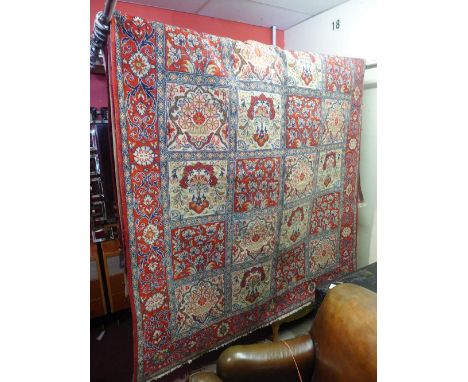 A central Persian qum carpet, 310cm x 193cm, having repeating panel garden motifs within stylised floral rouge borders.