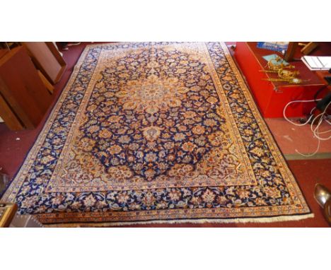 A large North west Persian carpet with central floral medallion contained by many borders on a blue and cream group 366cm x 2