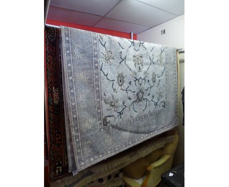 An Agra handmade blue carpet with triple central medallion contained by borders. 231cm x 161cm