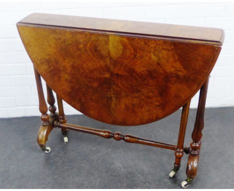 Walnut drop leaf table with turned supports terminating  on ceramic castors, 72 x 90cm 