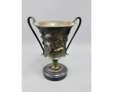 Bronze twin handled vase with ivy leaf pattern on a circular plinth base, 21cm high