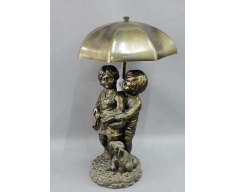 Bronze patinated resin water fountain of two children, modelled standing with their dog beneath an umbrella, 60cm high