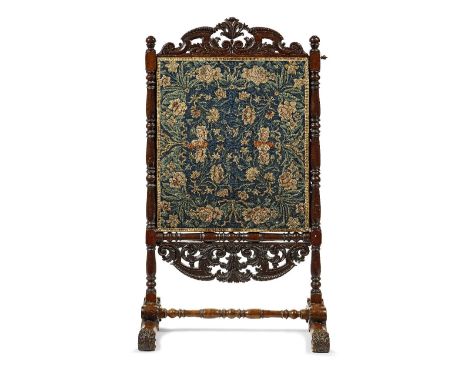 An 18th century crewelwork panel mounted within an adjustable Dutch 19th century walnut fire screenThe crewelwork panel decor
