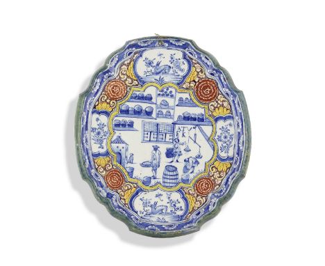 A Dutch Delftware oval plaque, circa 1750Decorated in polychrome colours with a rare interior scene of a spices shop, the ini