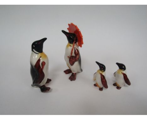 A Beswick Penguin with umbrella, model no. 802, Beswick Penguin with walking stick, model no. 802, Beswick Penguin chick mode