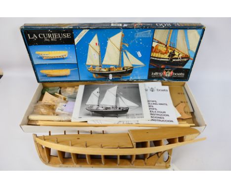 Billings Boats - A partially constructed wooden 1:25 scale Billings Boats #802 'La Curieuse' model kit. The hull of the ship 