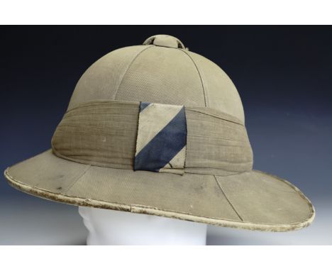 A British army officer's Wolseley pattern tropical helmet, having a blue-and-white striped silk pagri flash, inter-War / Seco