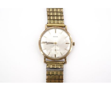 A 1960s Hefik 9 ct gold wristwatch, having a Swiss 17 jewel manual wing movement and radially brushed silver face, 33 mm, (a/