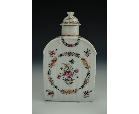 A late 18th / early 19th Century porcelain tea caddy, decorated with enamelled floral swags and sprays, 14 cm
