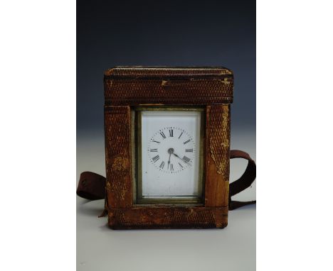 A late 19th Century carriage clock of diminutive stature, 7.5 cm excluding handle, in transit case with key