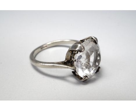 A vintage white sapphire solitaire ring, round-cut and crown set on a high-carat precious white metal shank, 11 mm, size K, s