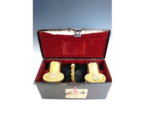 An early 20th Century Royal Navy officer's cocked hat, cased with full dress epaulettes and sword belt, the case bearing the 