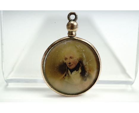 An Edwardian rolled gold double fob locket containing a portrait of Nelson and an image of HMS Victory, 21 mm