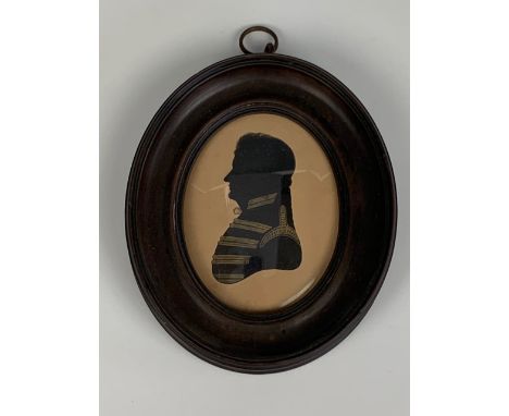 An early 19th Century bronzed silhouette of Major F Stupart, The Scots Greys, in oval ebonised and moulded frame under a conv