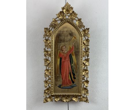 A late 19th Century Pre-Raphaelite influenced religious icon depicting an angel heralding with a trumpet, oil on panel, in a 