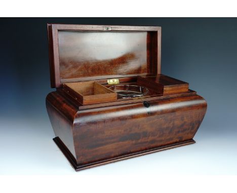 A William IV mahogany tea caddy, of shouldered sarcophagus form, containing a pair of wooden canisters and a cut glass bowl, 