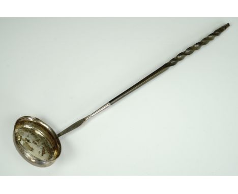 A George III white metal punch ladle, having a baleen handle, bearing engraved initials and date 1798, 37 cm