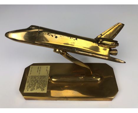 A brass desk model of the Space Shuttle Columbia, 24 cm x 10 cm x 17 cm high