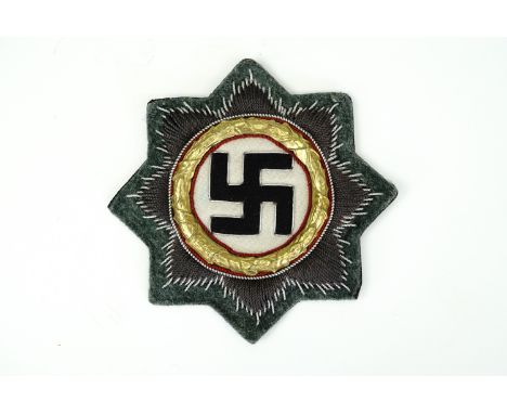 A German Third Reich War Order of the German Cross in Gold, on army / Waffen SS field grey cloth backing