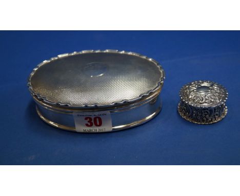 An engine turned oval silver jewellery box, by Percy James Finch, Birmingham 1922, 12cm; together with a silver circular pill