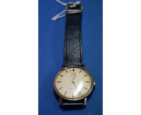 A vintage Omega 9ct gold gentleman's mechanical wristwatch, having a 3cm signed champagne dial decorated baton markers, cal 6