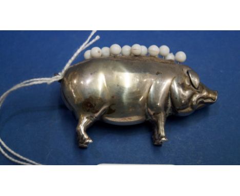 An Edwardian silver pig pin cushion, by C.S F.S, Birmingham 1905, 6.5cm.   Condition Report:  Body dented and tarnished.  Cor