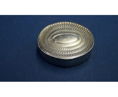 A George III oval silver vinaigrette, by T W, London, having engine turned and chased decoration, 3.3cm.
