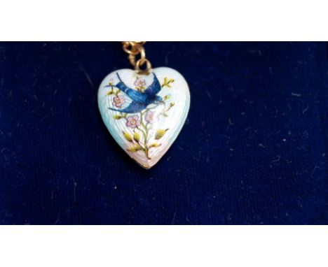 A Victorian 15ct and enamel Bluebird heart pendant on an unmarked chain.   Condition Report:  Denting to rear of heart.  Dama