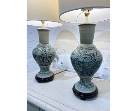 TABLE LAMPS, a pair, Chinese ceramic vase form decorated with fish, with carved hardwood bases and shades, 65cm H. (2) 