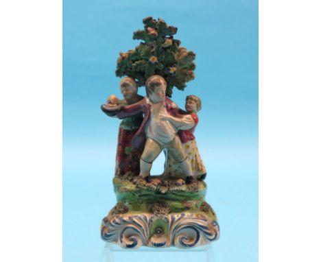 An 18th century Walton pearlware figure group, male attempting to protect his haul, on mound base painted with scrolls in blu