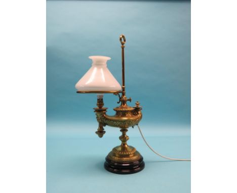 A German cast brass oil lamp, Wild & Wessel Patent, ancient Egyptian style on black ceramic plinth, with glass shade, 23in. -