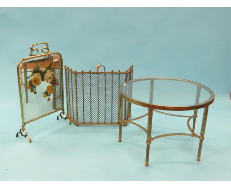 A folding cast brass fireguard, together with a Victorian brass fireguard with inset painted mirror and a circular brass occa
