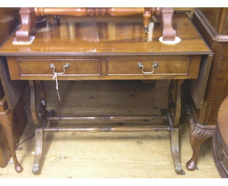 A reproduction mahogany sofa table, half-veneered top above two frieze drawers, on lyre end supports and brass paw casters, 3