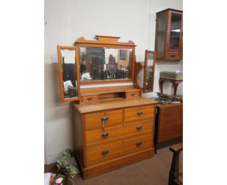 A satin walnut dressing chest, rectangular bevelled mirror adjustable above two trinket drawers, two short and two long drawe