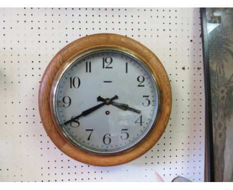 A Victorian dial clock, 9.5in. silvered dial and oak surround, with key