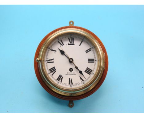 A Smith's ship's clock, 6in. enamel dial with centre-seconds, spun brass case, on mahogany mount, with key