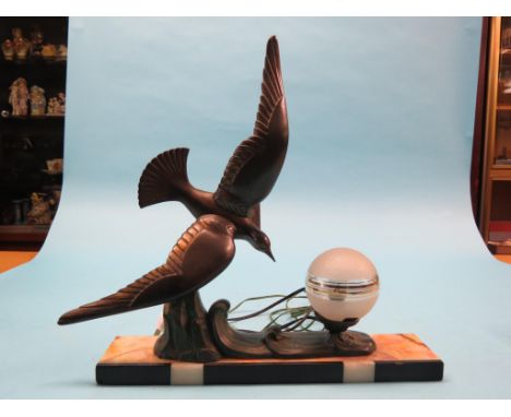 An Art Deco-style table lamp, cast metal bird design with bronzed finish, globular glass shade, rectangular onyx base, 18in.