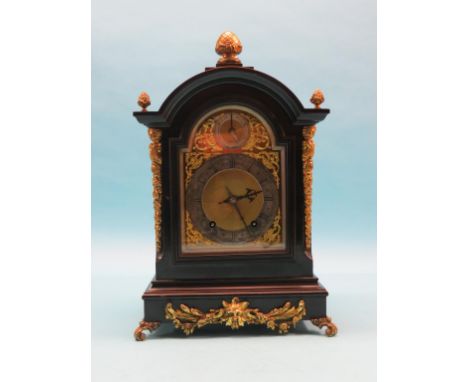 A late 19th century ebonised bracket clock in Georgian style, arched brass dial with silvered chapter ring and regulator, Ger