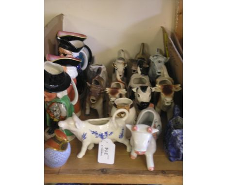 Various Victorian-style cow-creamers, four various character jugs and a Royal Crown Derby bird flask 