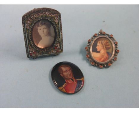 A .800 silver portrait miniature brooch, female bust, indistinctly signed, and two other portrait miniatures, one contained w