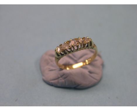 An 18ct. gold and diamond half-hoop ring, five graduated diamonds in claw settings, size K