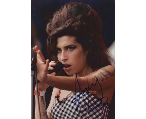 WINEHOUSE AMY: (1983-2011) English Singer. Signed colour 8 x 11.5 photograph of Winehouse in a head and shoulders pose singin